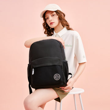 woman holding a black backpack of anta