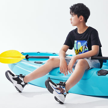 a kid wearing sports shoes of anta