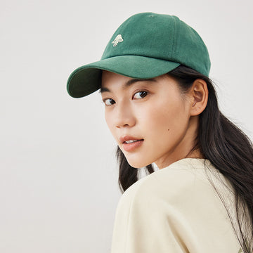 woman wearing a green cap